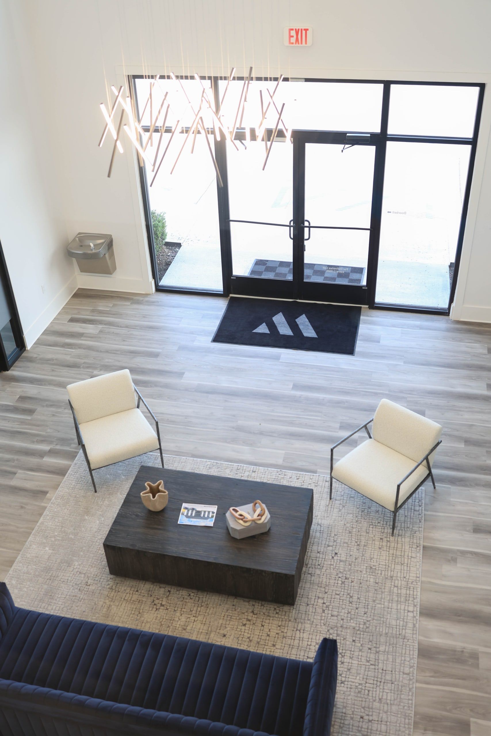 Lobby at The W Office Suites Looking down into the double-height lobby at The W Office Suites, with the W logo doormat at the front doors